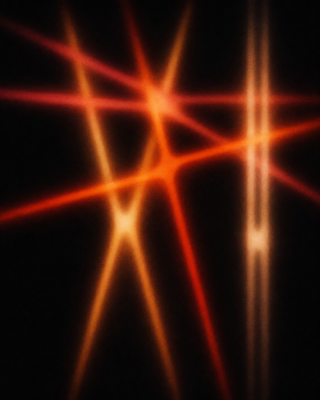 An abstract network of warm light emerging from darkness