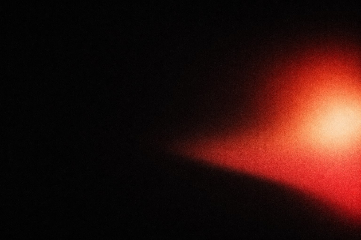 A warm signal of light emerging from darkness