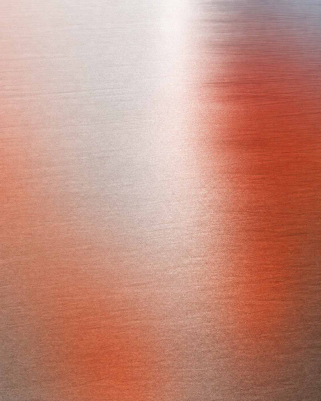 An abstract copper texture shifting from soft gray to warm red